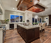 Fully featured kitchen with off white perimeter and stained maple island
